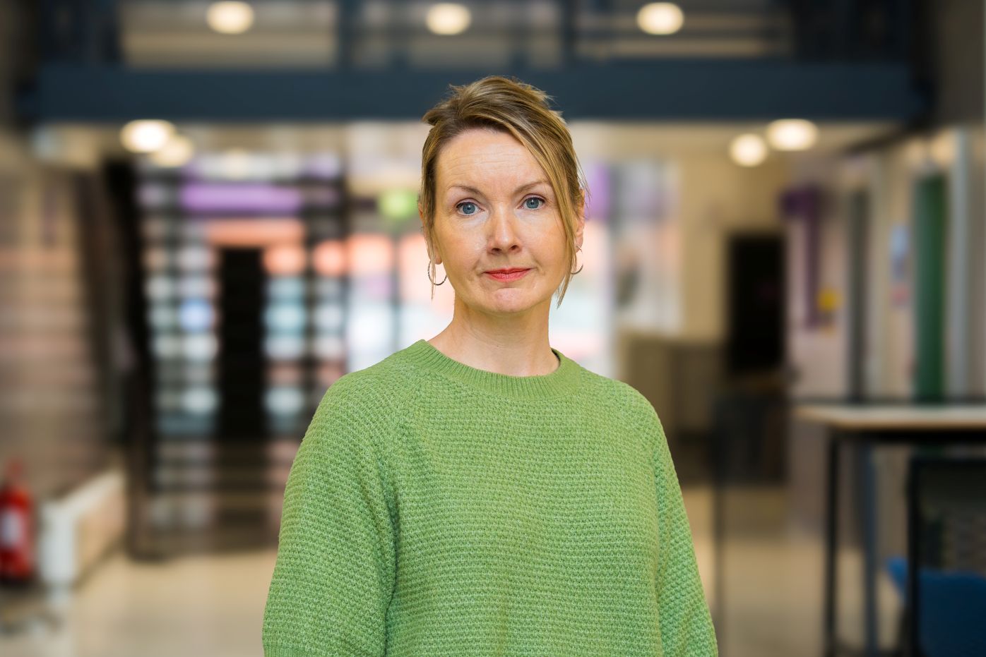Female academic, Rachel Purcell, wearing a green jumper